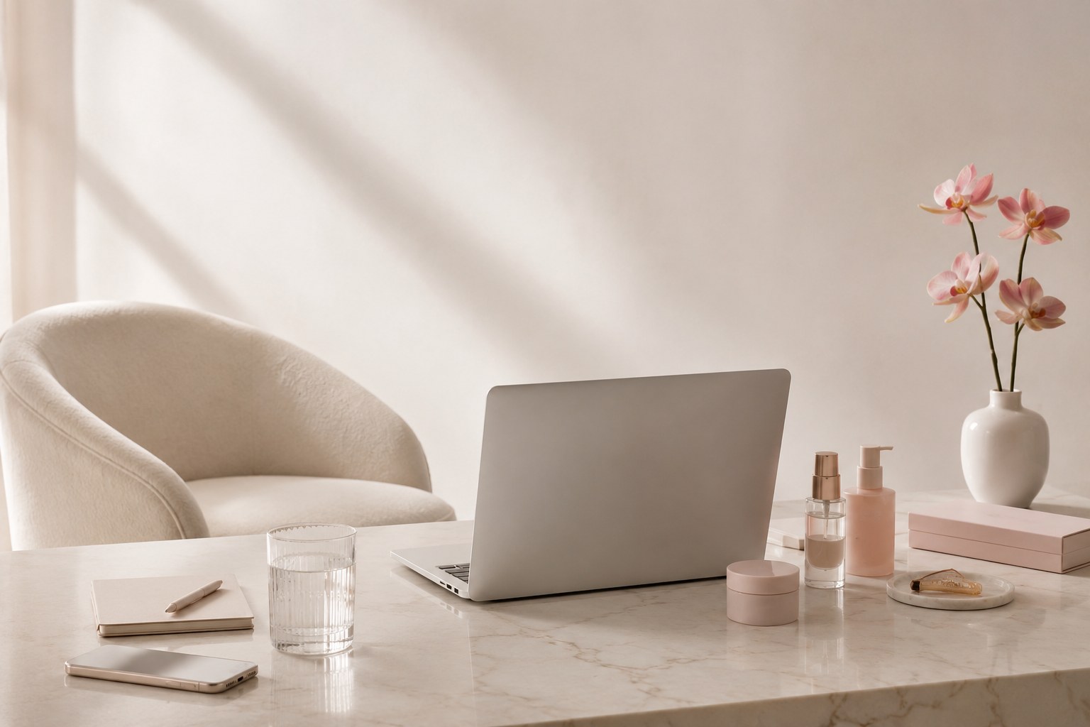 Soft neutral beauty business workspace with laptop and blush details